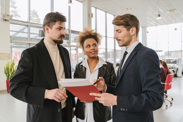 customer and car salesperson going over a car lease